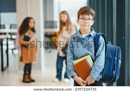Schoolboy with schoolbag and books in the school. Back to school.