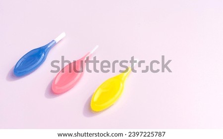Mockup Colorful Dental Brushes Between Teeth Gum Braces on Pink Background, Interdental Brush Toothpick with Soft Bristles, Oral Tooth Cleaning Tool. Copy Space For Text, Horizontal Plane Royalty-Free Stock Photo #2397225787