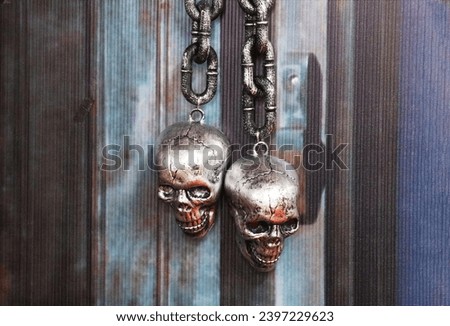 metal skulls on a chain                        Royalty-Free Stock Photo #2397229623