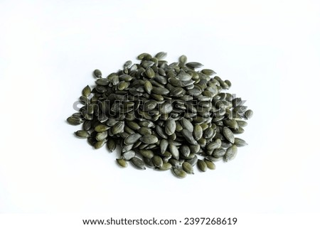 Natural green pumpkin seeds without shell isolated on white background. Healthy food concept. Overhead view. Copy space. Royalty-Free Stock Photo #2397268619