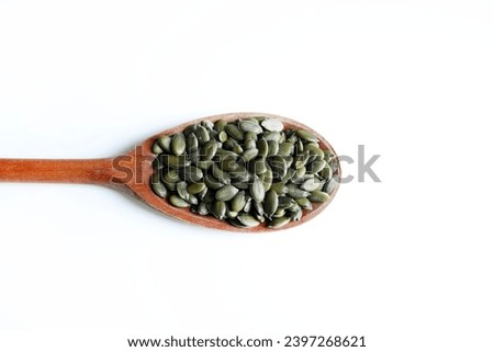 Natural green pumpkin seeds without shell isolated on white background. Healthy food concept. Overhead view. Copy space. Royalty-Free Stock Photo #2397268621