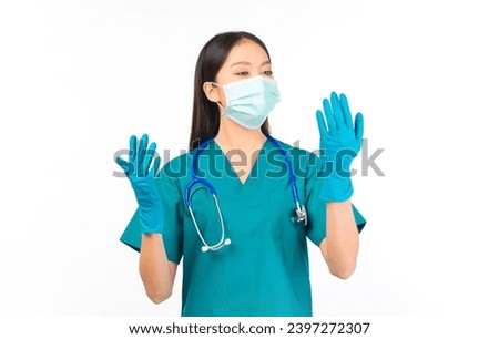 portrait asian female doctor in scrubs standing protection flu cold facial with mask wearing surgical gloves.