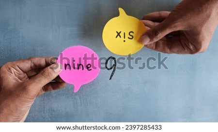Hand holding speech bubble with text NINE and SIX. Different perception, perspective and argument Royalty-Free Stock Photo #2397285433