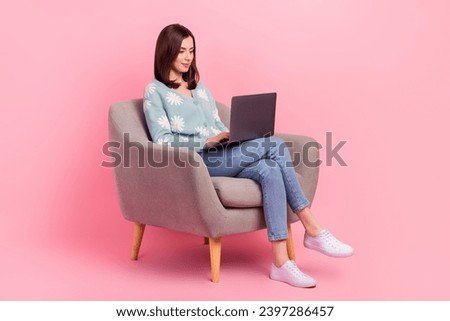 Full length body photo of concentrated young assistant woman work remote sitting armchair with laptop isolated on pink color background Royalty-Free Stock Photo #2397286457