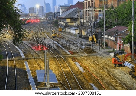 Bangkok Central Station Hua Lamphong at night can see the train tracks reflecting the light in curves.