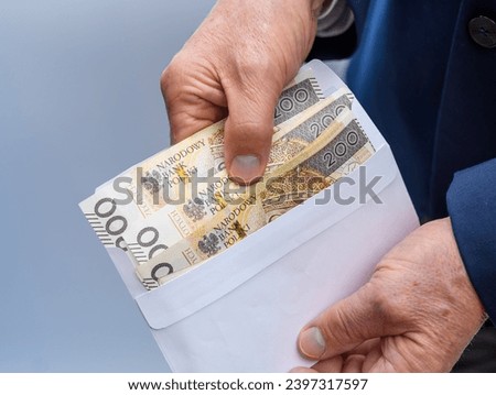 Money taken out in Polish currency from a paper envelope