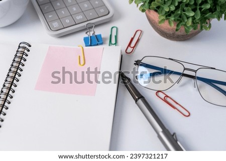 Top view workspace with empty notebooks, glasses and sticky notes.