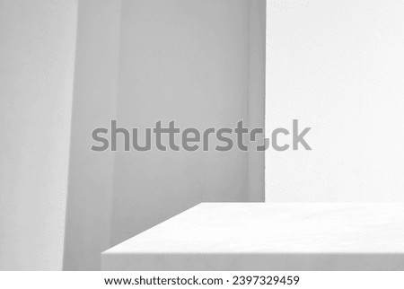 Minimal White Marble Table Corner with Illuminated Concrete Wall Background, Suitable for Product Presentation Backdrop, Display, and Mock up. Royalty-Free Stock Photo #2397329459