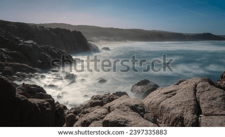 Long exposure photography at Lu Pultiddolu just before sunset. The stormy sea crashes onto the rocks of the coast, creating the fog that makes the landscape feel like something out of a fairy tale