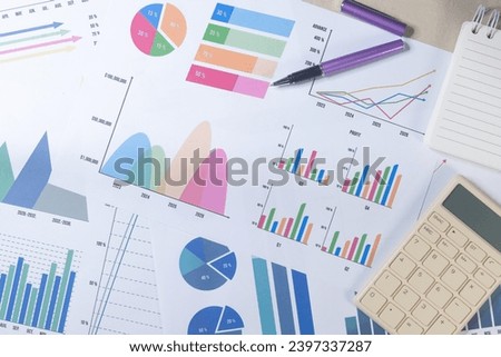 Calculator and Pen with Business Graphs finance document. Royalty-Free Stock Photo #2397337287