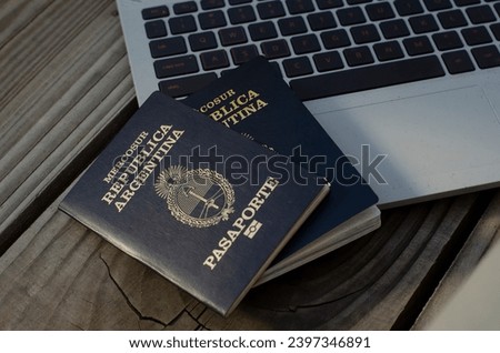 Argentine passport with PC in the background taking out airfare. document to leave the country for travel