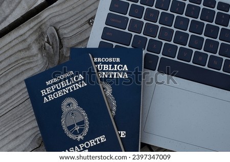 Argentine passport with PC in the background taking out airfare. document to leave the country for travel