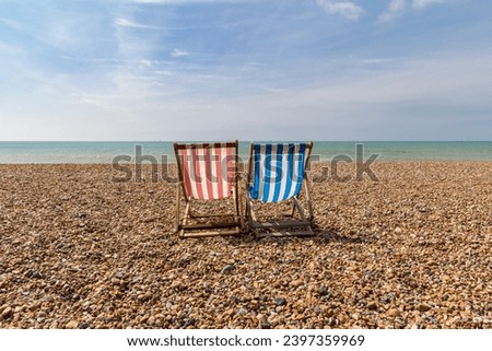 Deck Chairs on the beach, Brighton, East Sussex, England, UK Royalty-Free Stock Photo #2397359969