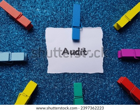 Audit text on blue background.