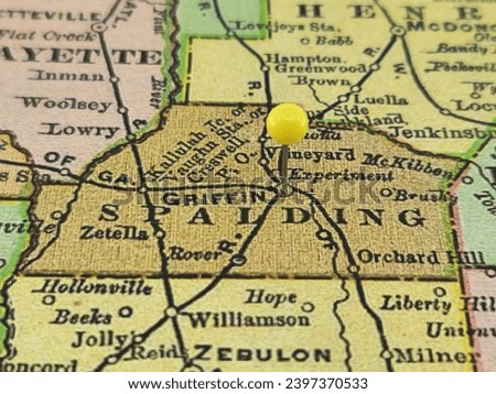 Spalding County, Georgia marked by a yellow tack on a colorful vintage map. The county seat is located in the city of Griffin, GA. Royalty-Free Stock Photo #2397370533