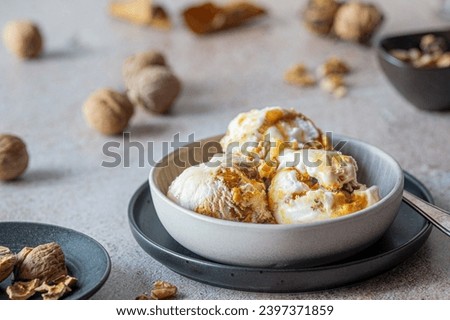 walnut ice cream in a dessert bowl, nuts around