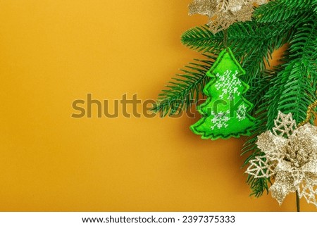 Traditional New Year composition.Festive handmade decor, felt Christmas trees embroidered with a cross. Holiday time, apricot background, place for text
