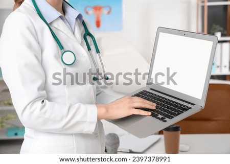 Female doctor working with laptop in clinic, closeup Royalty-Free Stock Photo #2397378991