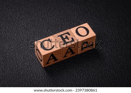 The inscription ceo in wooden cubes on a dark concrete background. Can be used as part of your composition
