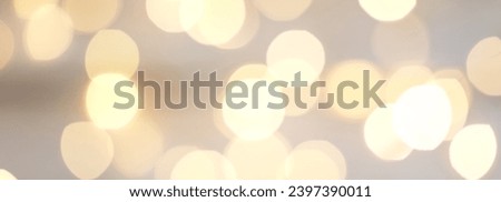 Bokeh effect. Defocused. Template mock up for holiday card. Copy space for text. Background with abstract golden sparkling Christmas festive lights. Banner