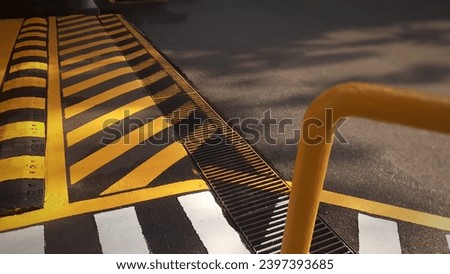 
Appearance of asphalt  and a slight zebra crossing with hand rails from the side angle.
