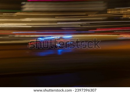 Abstract Police Car on the road with motion blur background. long shutter speed. Grain. Blurred.