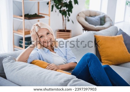 Photo portrait of attractive pensioner woman sitting sofa charming relaxing weekend living room modern interior decoration