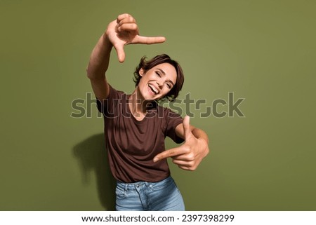 Photo portrait of lovely young lady hands gesture photographing frame dressed stylish brown garment isolated on khaki color background