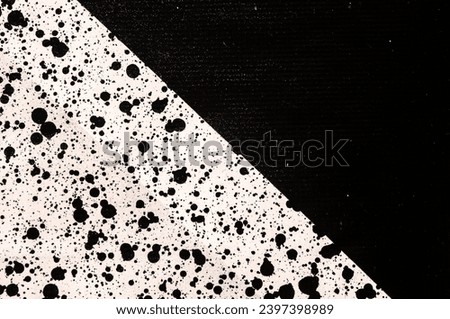 Splattered pf black ink drops on white background