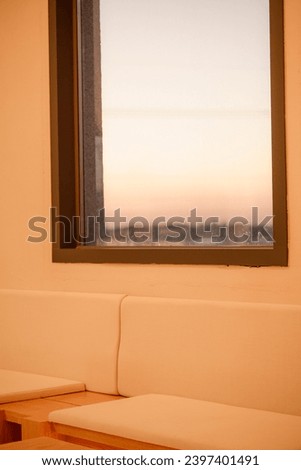 A Window View at Sunset : This is a photo of a window with a view of the horizon at sunset. The photo has a warm and peaceful mood.