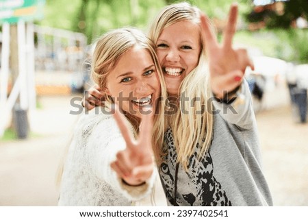 Portrait, outdoor festival and happy friends peace sign, celebrate or happiness for fun bonding, rave party or social gathering. Music concert, emoji V icon and girl hand sign for entertainment event Royalty-Free Stock Photo #2397402541