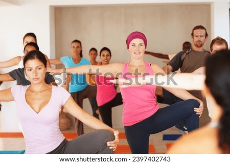 Yoga class, stretching knee and people with coach at gym, exercise and healthy body or wellness. Fitness, happy group and instructor practice flexibility, balance legs and pilates in club together Royalty-Free Stock Photo #2397402743