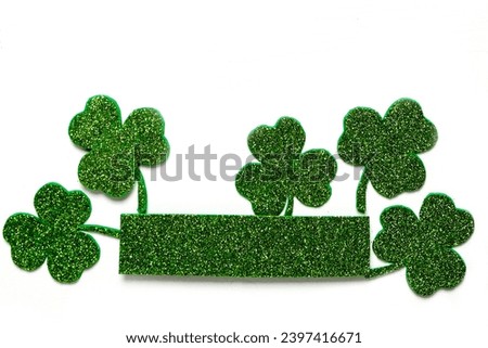 Happy St. Patrick's Day banner.Holiday background.St Patricks Day frame against a white background. Flat lay shamrocks.Copy space.Patrik's day banner Royalty-Free Stock Photo #2397416671