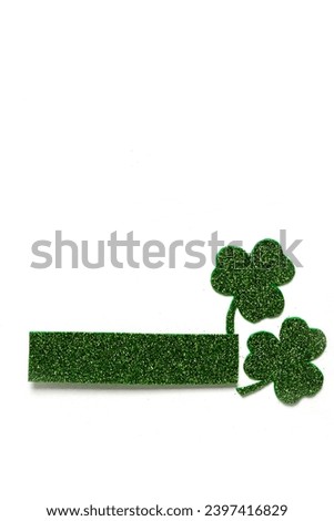 Happy St. Patrick's Day banner.Holiday background.St Patricks Day frame against a white background. Flat lay shamrocks.Copy space.Patrik's day banner Royalty-Free Stock Photo #2397416829