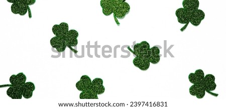 Happy St. Patrick's Day banner.Holiday background.St Patricks Day frame against a white background. Flat lay shamrocks.Copy space.Patrik's day banner Royalty-Free Stock Photo #2397416831