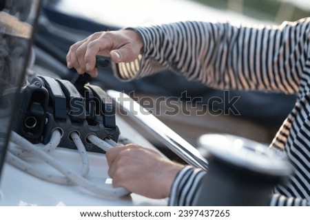 Close up picture of mans hands fixing a rope