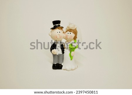 Wedding couple or wedding figure or wedding cake topper made of ceramic on a white background