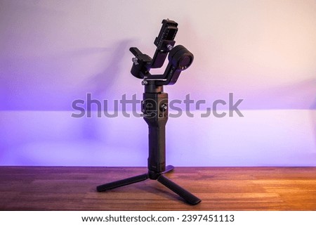 Professional Black Gimbal Stabilizer Tripod Standing on Wooden Surface