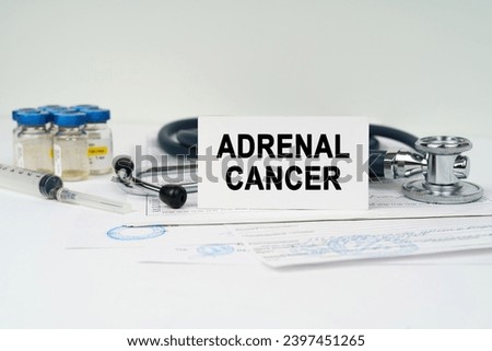 Medical concept. On the medical documents there is a stethoscope, injections, a syringe and a business card with the inscription - adrenal cancer