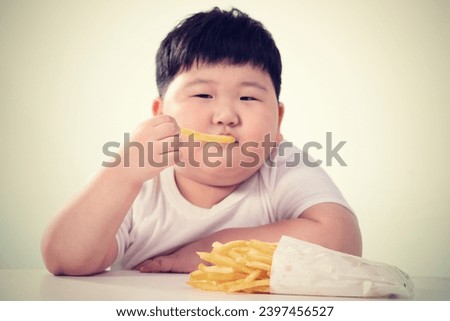 Lovely fat boy eat french fries