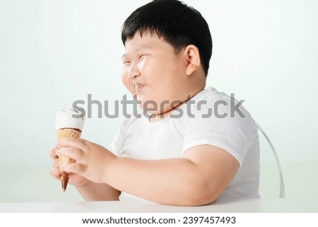 Lovely fat boy eating ice cream