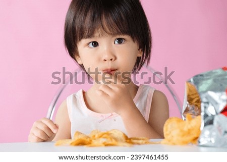 Lovely boy eating potato chips