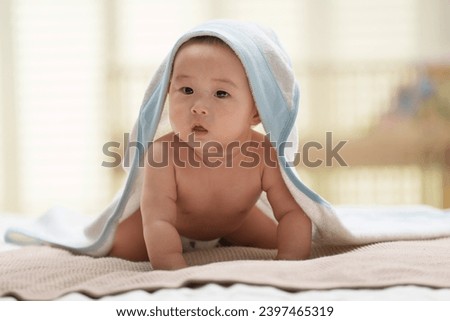 Cute baby lying on bed playing