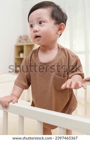 Cute baby playing in crib