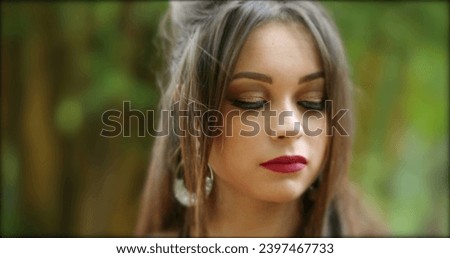 Pretty hispanic girl adjusting hair posing to camera. Young millennial woman in hero 20s in outdoor park