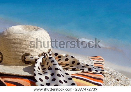 Women's hat against the background of the turquoise ocean and blue clouds. Winter holiday on the shore of the warm ocean.
