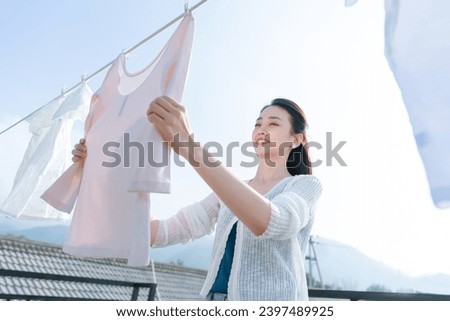 Chores laundry women clothesline clothing Royalty-Free Stock Photo #2397489925