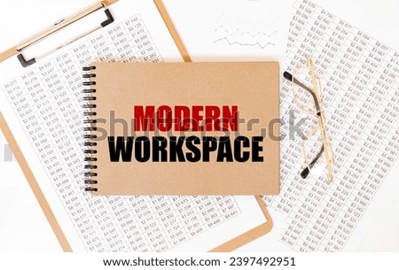 Craft colour notepad with text MODERN WORKSPACE. Notepad with eyeglasses and text documents. Business concept
