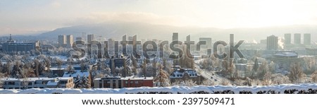Panoramic view of snow covered Zurich city Switzerland during winter. Above vista point of view, snowy rooftops, no people.