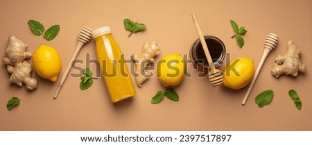 Composition with detox drink, lemons, mint, ginger, honey in glass jar and honey wooden dippers top view. Food for immunity stimulation and against flu. Healthy natural remedies to boost immune system Royalty-Free Stock Photo #2397517897